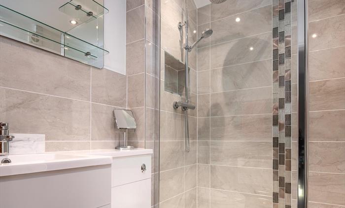 The bathroom has a large walk-in drench shower which runs from the mains water and so has very good pressure.